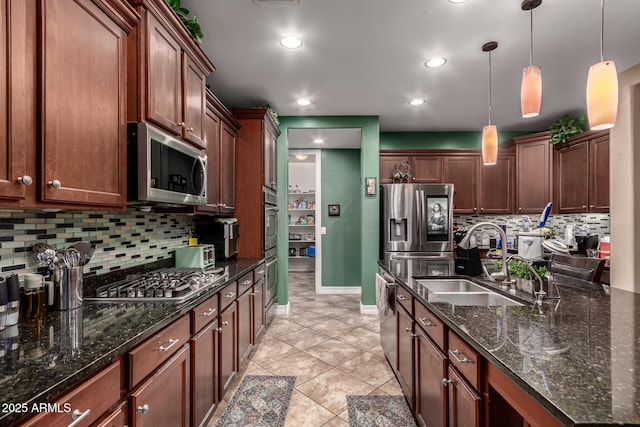 kitchen featuring light tile patterned floors, sink, pendant lighting, and appliances with stainless steel finishes