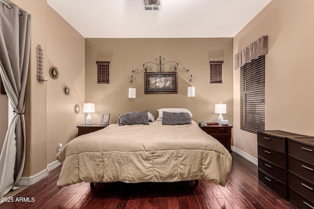 bedroom with dark hardwood / wood-style floors