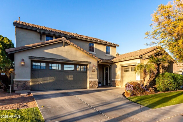 mediterranean / spanish home with a garage