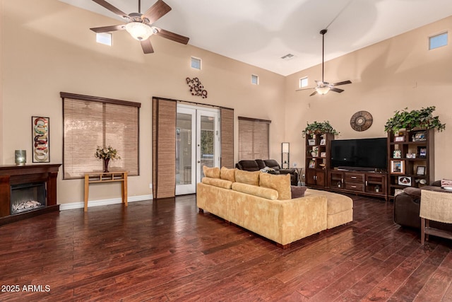 living room featuring ceiling fan, dark wood-type flooring, and french doors