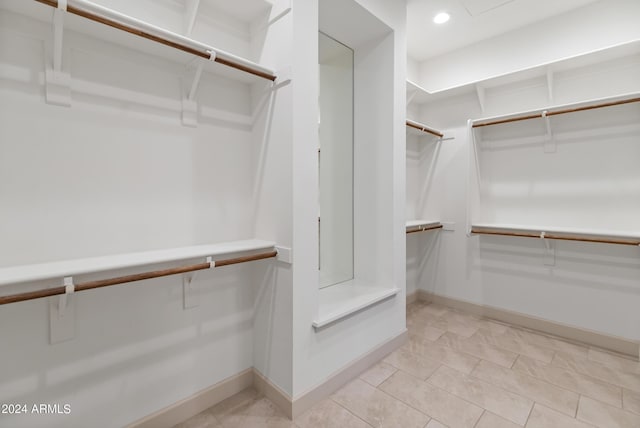 spacious closet featuring light tile patterned floors