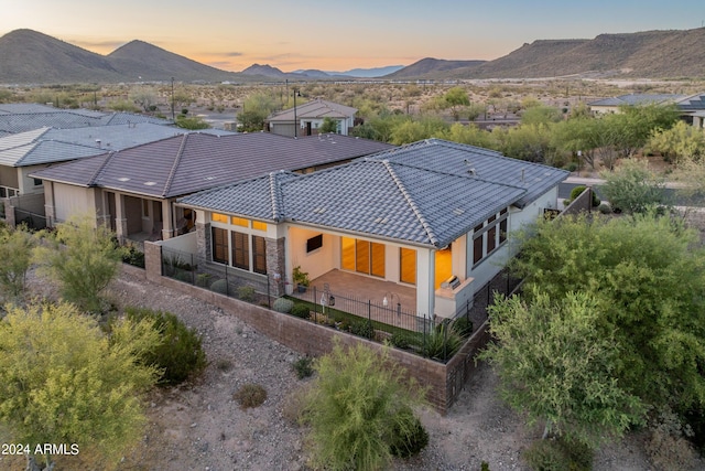 back house at dusk featuring a mountain view