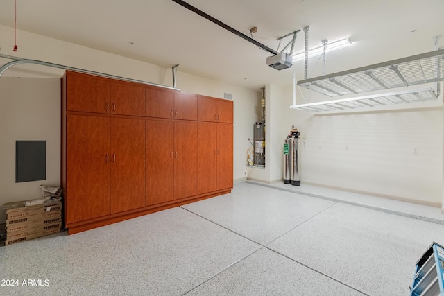 garage with a garage door opener and water heater