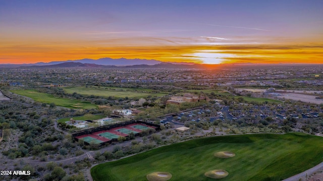 aerial view at dusk featuring a mountain view