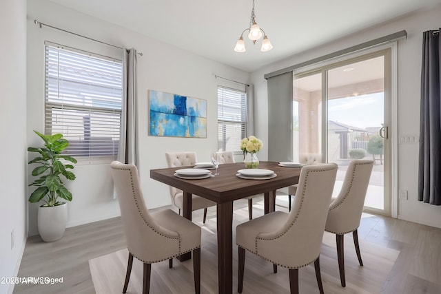 dining space featuring a chandelier and light hardwood / wood-style floors