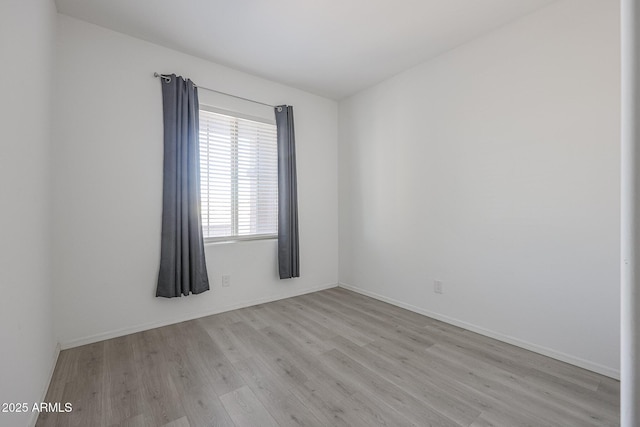 empty room with light hardwood / wood-style floors