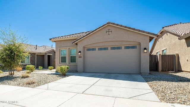 16543 W Alameda Rd, Surprise, AZ 85387 - mediterranean / spanish-style house with driveway, stucco siding, fence, an attached garage, and a tiled roof