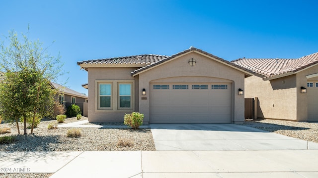 mediterranean / spanish-style home featuring a garage