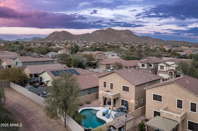 aerial view at dusk featuring a mountain view