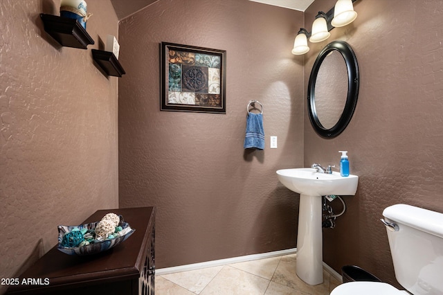 bathroom with toilet and tile patterned flooring