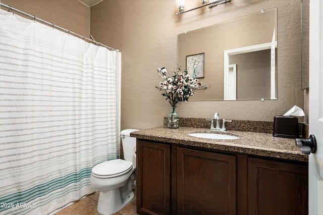 bathroom with tile patterned floors, toilet, and vanity