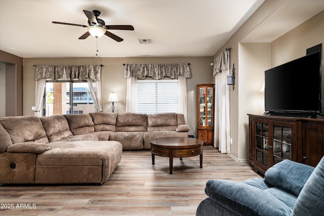 living room featuring ceiling fan and light hardwood / wood-style floors