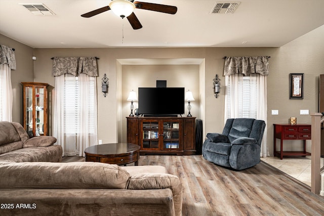 living room featuring ceiling fan and light hardwood / wood-style flooring