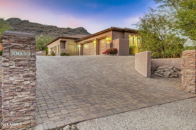 view of front of property featuring a mountain view and a garage