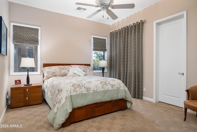 bedroom with ceiling fan and light carpet