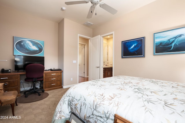 carpeted bedroom featuring ceiling fan and ensuite bathroom