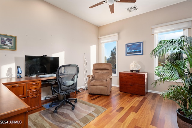 office with light wood-type flooring, plenty of natural light, lofted ceiling, and ceiling fan