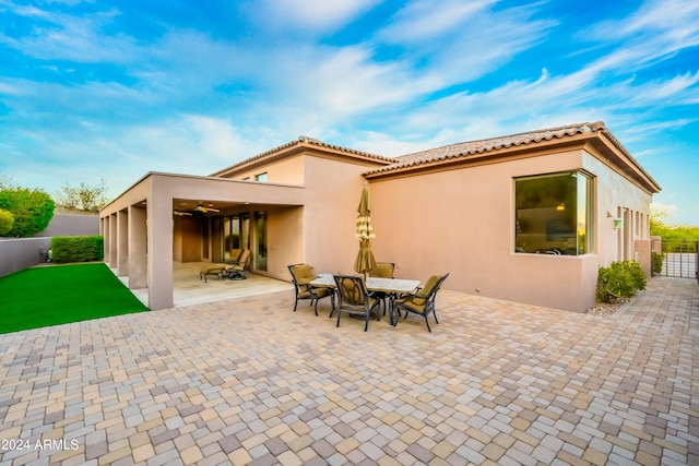 rear view of property featuring a patio area and ceiling fan