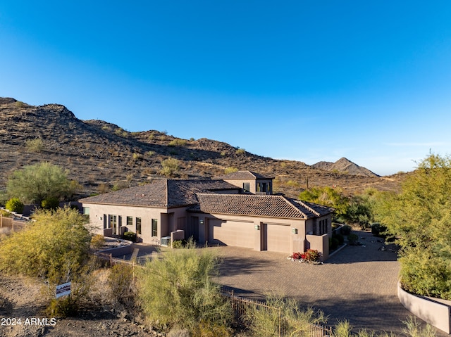 view of front facade featuring a mountain view and a garage