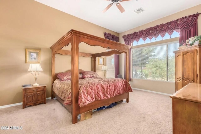 bedroom with ceiling fan and light colored carpet