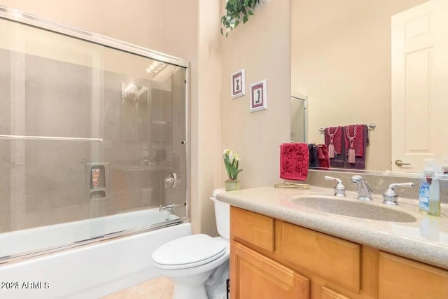 full bathroom with tile patterned flooring, vanity, toilet, and bath / shower combo with glass door