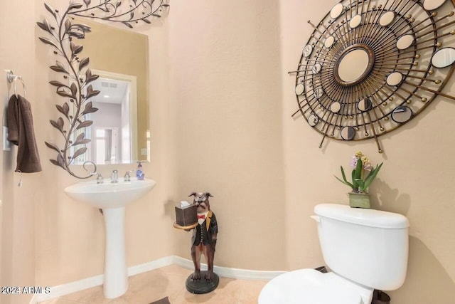 bathroom featuring sink, toilet, and tile patterned floors