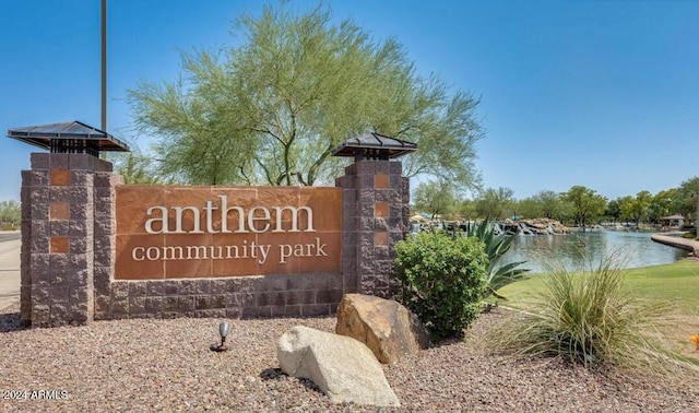 community / neighborhood sign with a water view