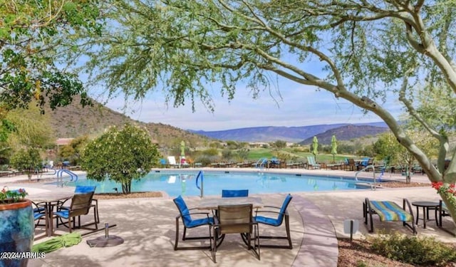 view of pool featuring a patio and a mountain view