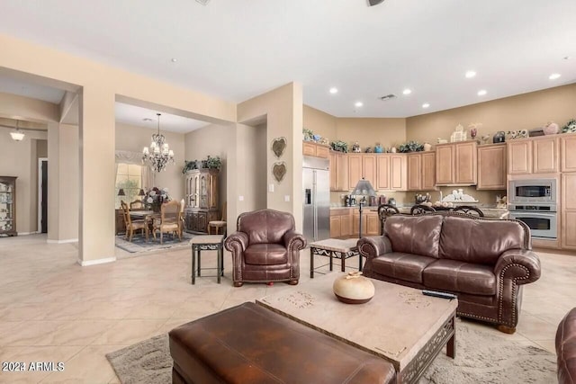 tiled living room with a notable chandelier