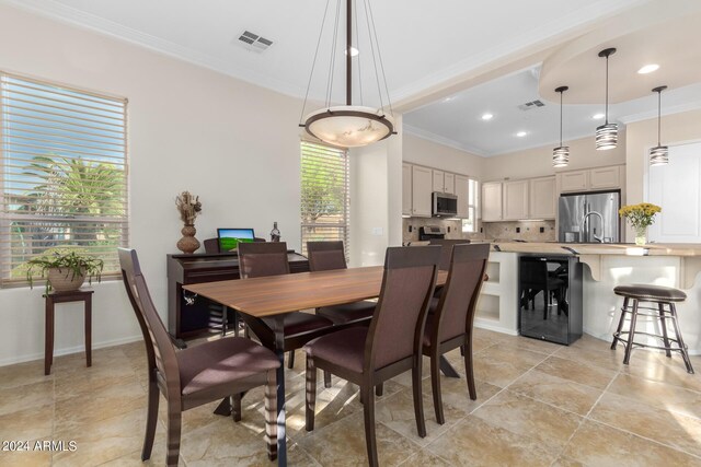 dining area featuring beverage cooler and ornamental molding