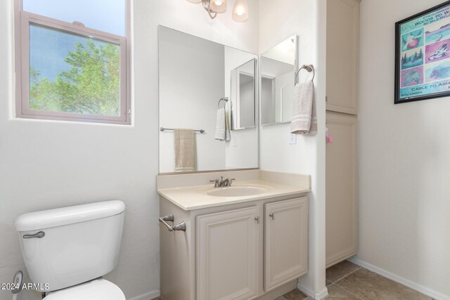 bathroom featuring tile patterned flooring, vanity, and toilet