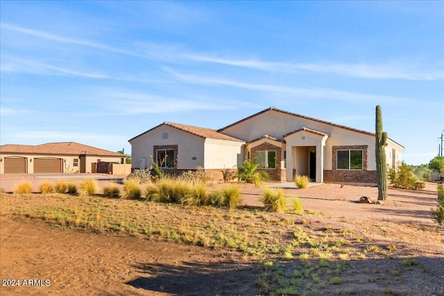 mediterranean / spanish-style house with a garage