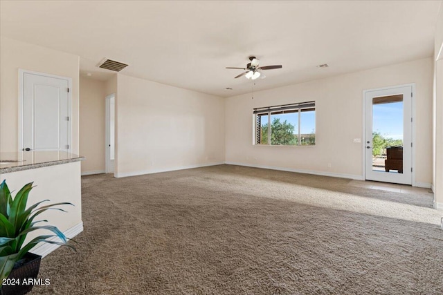 unfurnished living room featuring carpet flooring and ceiling fan