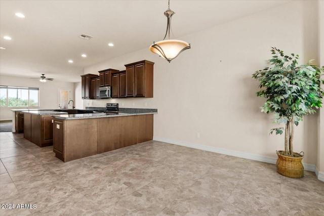 kitchen featuring kitchen peninsula, light stone counters, stainless steel appliances, ceiling fan, and hanging light fixtures