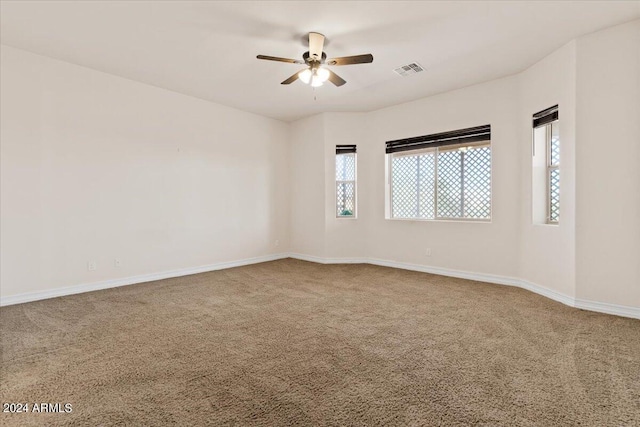 unfurnished room featuring carpet and ceiling fan