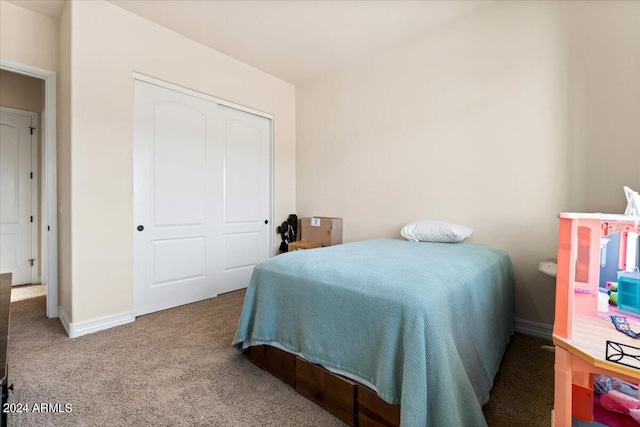 carpeted bedroom featuring a closet