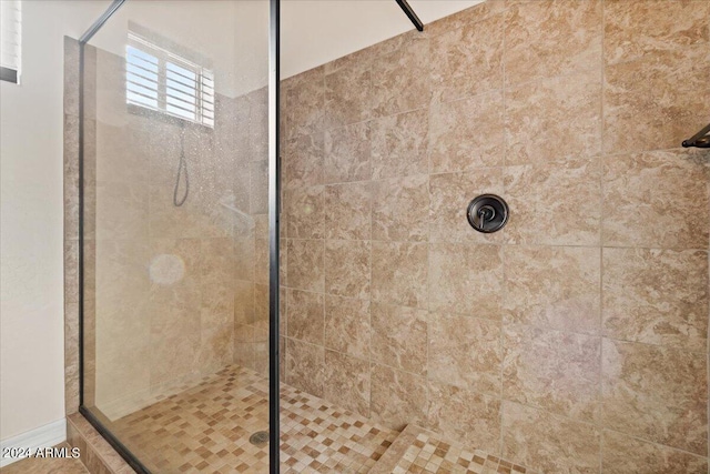 bathroom with a tile shower