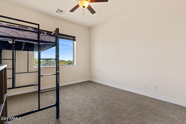 unfurnished bedroom featuring carpet flooring and ceiling fan