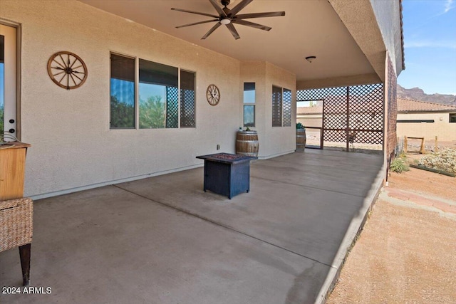 view of patio / terrace featuring ceiling fan and a mountain view