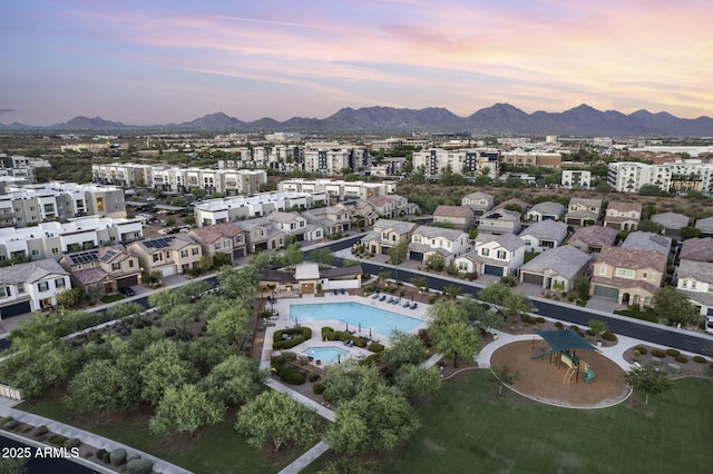 aerial view at dusk featuring a mountain view