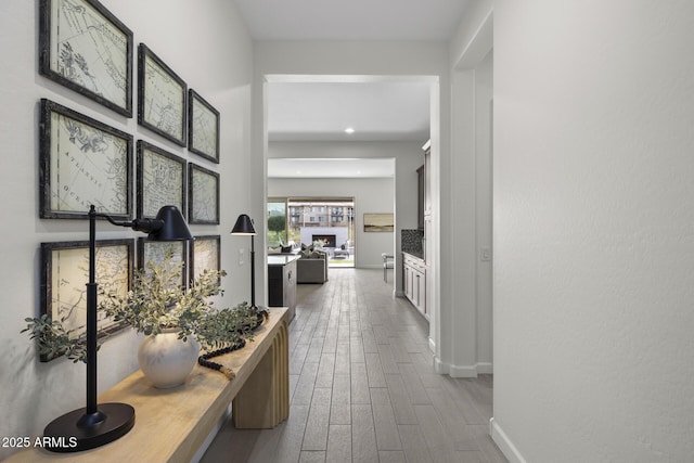 hall featuring dark wood finished floors and baseboards