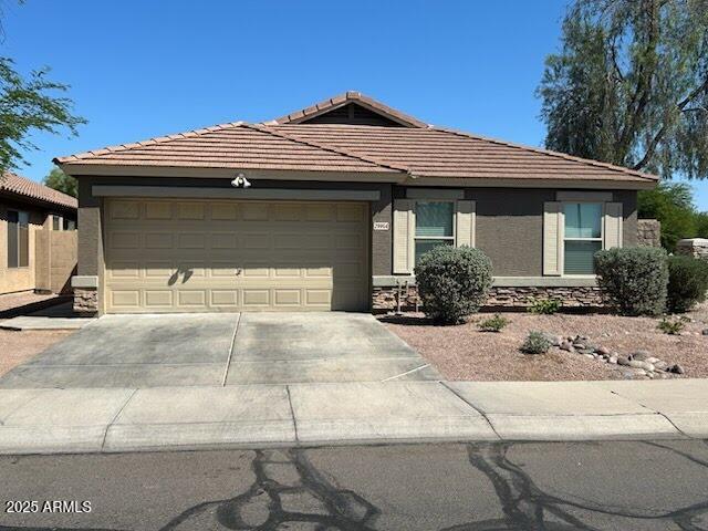 29954 N Broken Shale Dr, San Tan Valley, AZ 85143 - ranch-style house with concrete driveway, a garage, a tiled roof, and stone siding