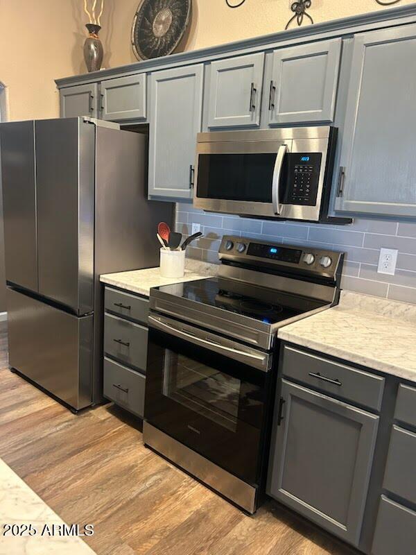 29954 N Broken Shale Dr, San Tan Valley, AZ 85143 - kitchen featuring appliances with stainless steel finishes, gray cabinets, and light wood-type flooring