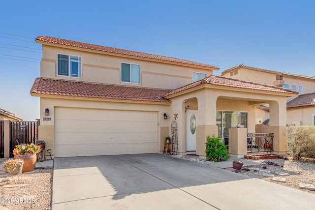 mediterranean / spanish-style house featuring driveway, fence, and stucco siding