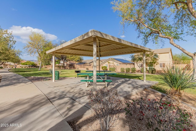 view of community featuring a gazebo, a lawn, a patio, and fence