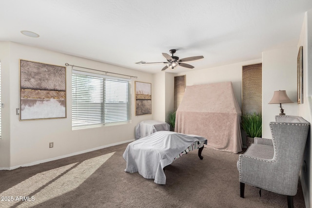 living area with carpet flooring, ceiling fan, visible vents, and baseboards