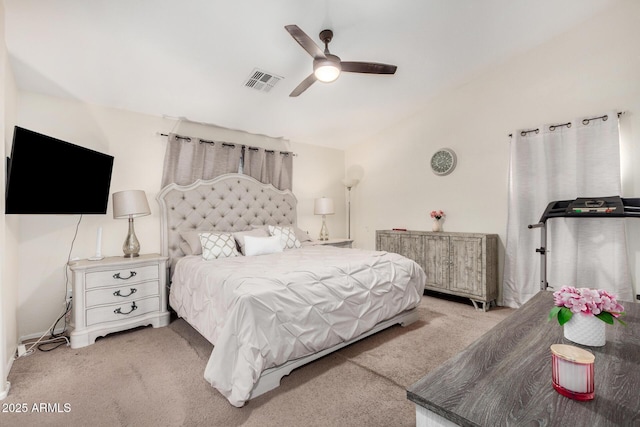 carpeted bedroom with lofted ceiling, visible vents, and a ceiling fan