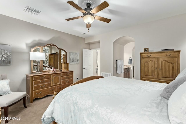 carpeted bedroom featuring connected bathroom and ceiling fan