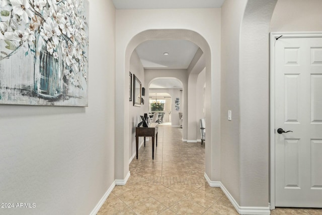 corridor featuring light tile patterned floors