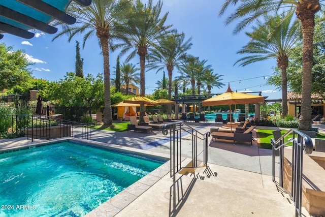 view of swimming pool with a patio area and a pergola